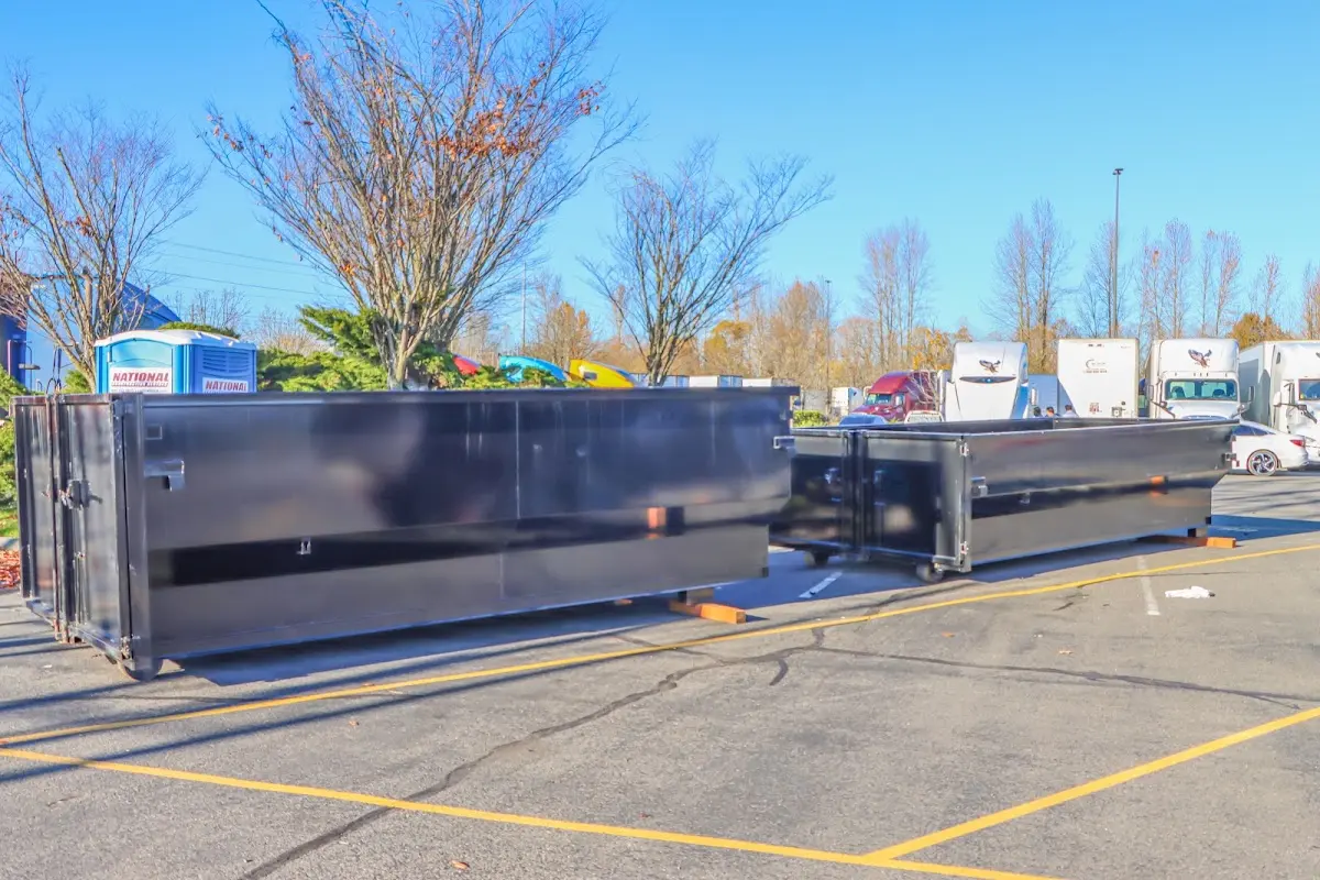 Professional dumpster rental service with roll-off container on residential driveway in Olivette